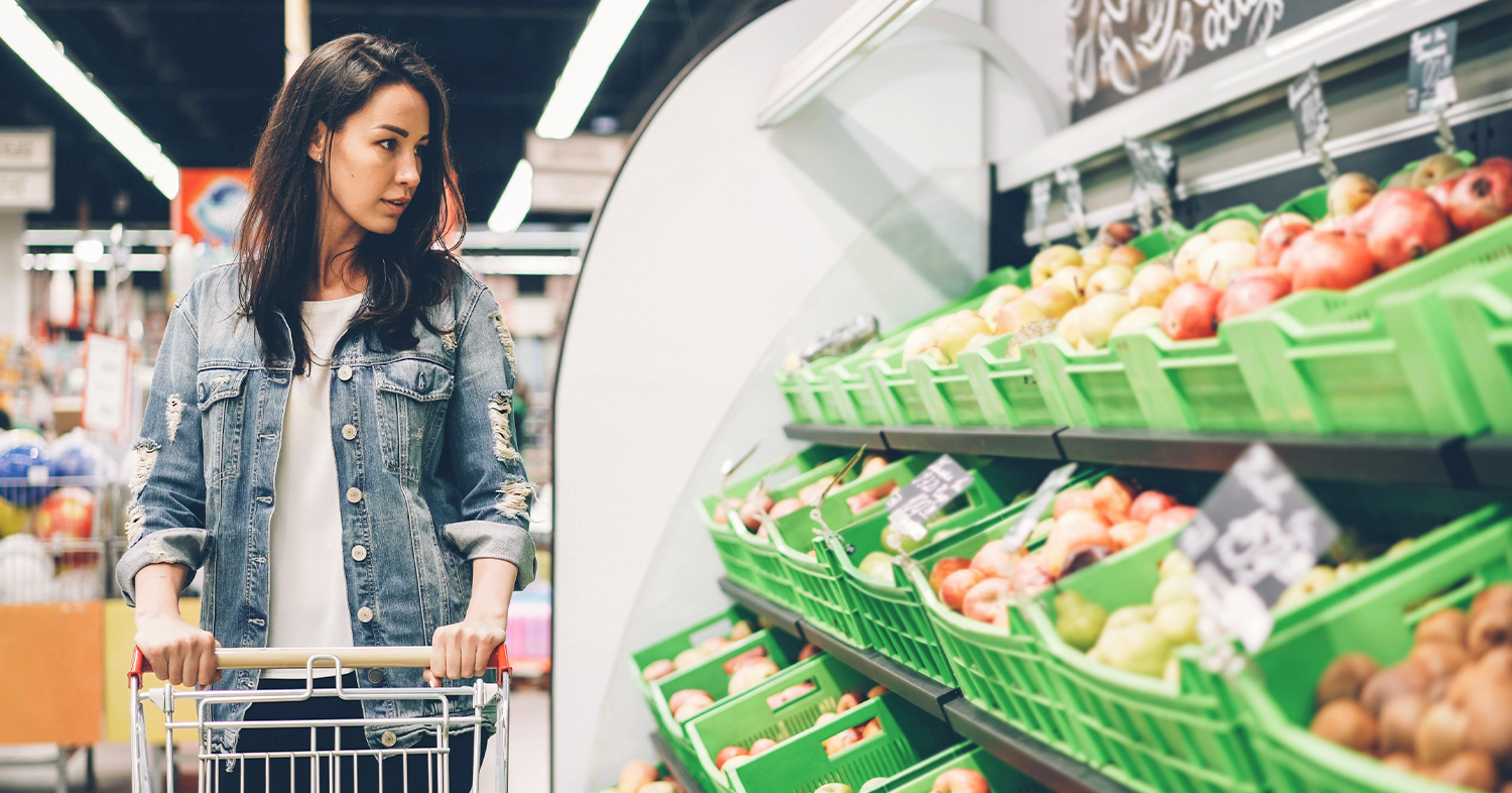 A photo of a women shopping in a grocery store.
